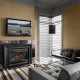 A fireplace and sofa in a Luxury Suite at Hotel Arts Kensington, Calgary, AB