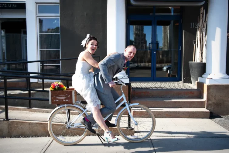 Newlyweds on a complimentary bicycle at Hotel Arts Kensington, Calgary, AB